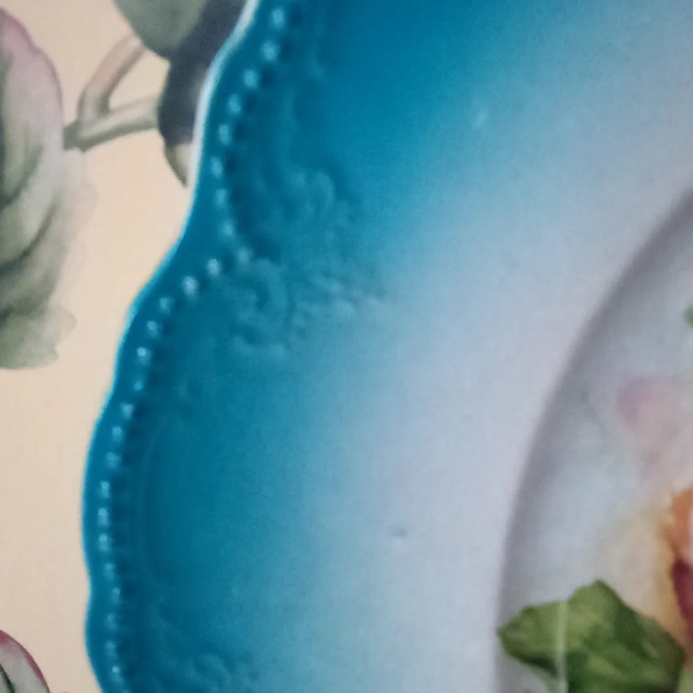 Hand painted calendar advertising plate from 1910. Turquoise & roses